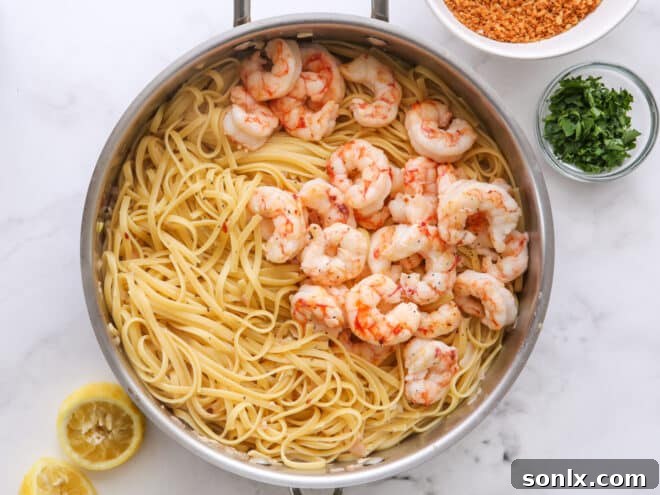 step 4: add shrimp to pasta and toss everything together in a skillet