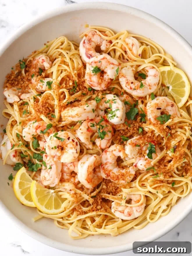 shrimp scampi in bowl, garnished with parsley