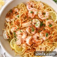 closeup of shrimp scampi pasta in a big bowl, garnished with parsley