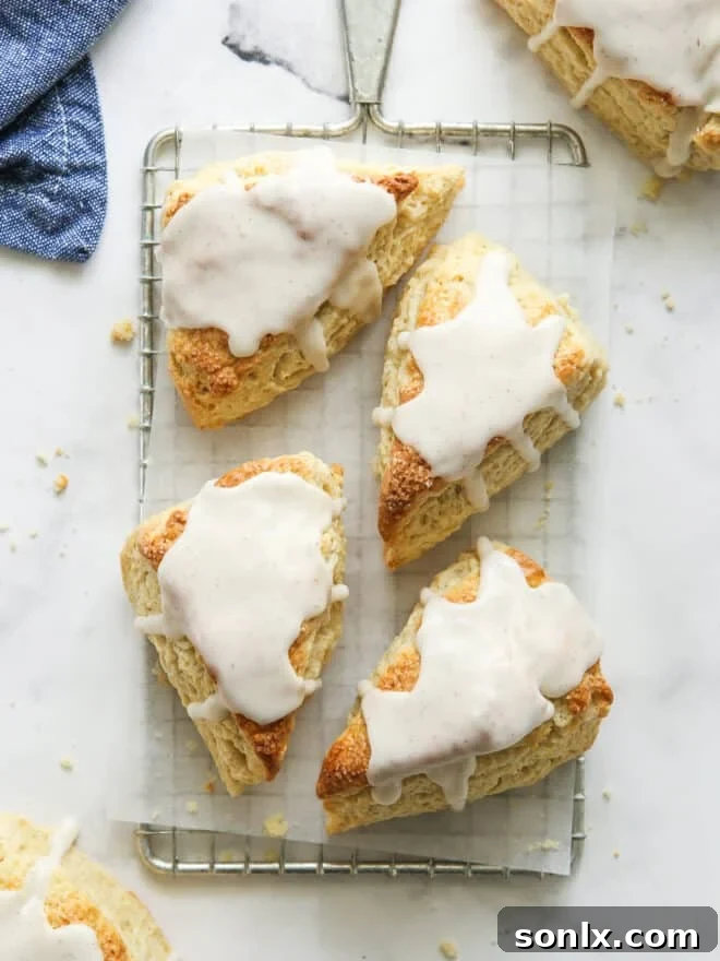 vanilla bean scones with frosting on a wire rack