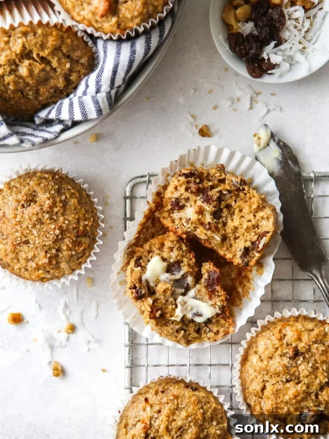 Two freshly baked bran muffins cooling on a wire rack.
