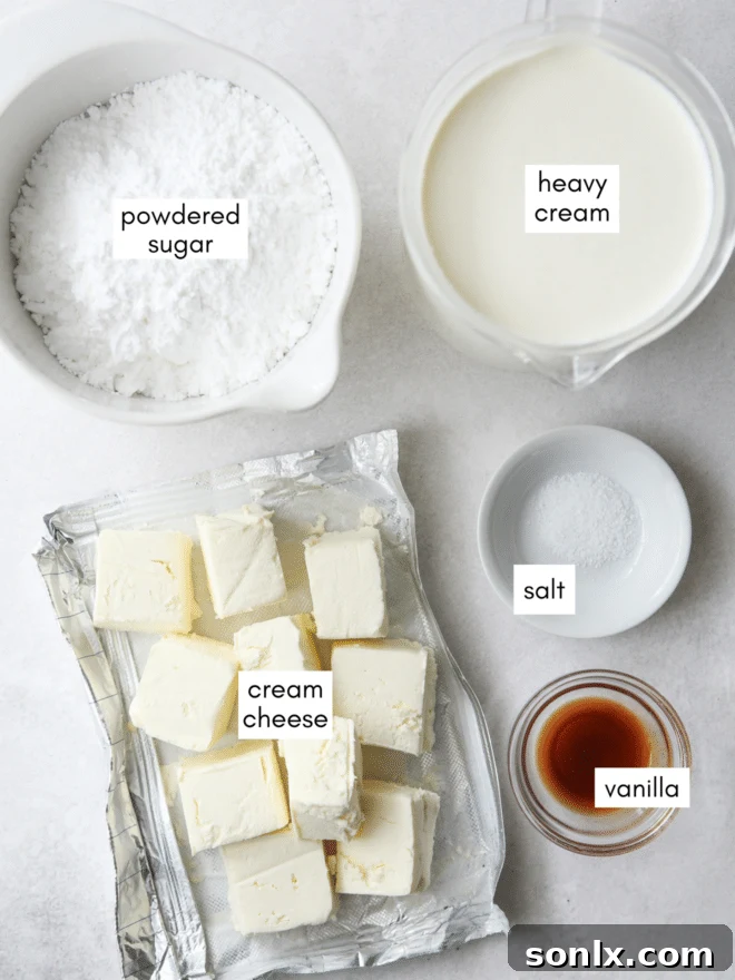 Various ingredients laid out for making Chantilly cream frosting, including cream cheese, heavy cream, powdered sugar, and vanilla extract.
