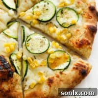 Close up of zucchini pizza with a drizzle of hot honey on it