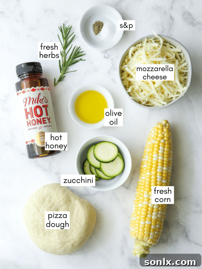 Arrangement of fresh zucchini corn pizza ingredients, including pizza dough, cheese, corn, zucchini, herbs, and hot honey, clearly labeled for easy identification