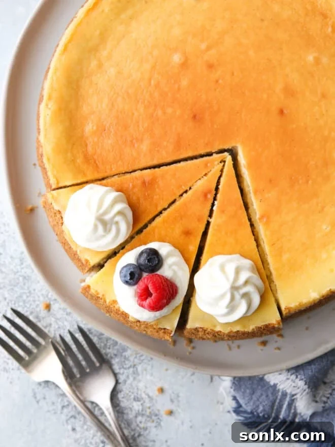 A slice of perfectly baked, crack-free cheesecake on a plate, ready to be enjoyed.
