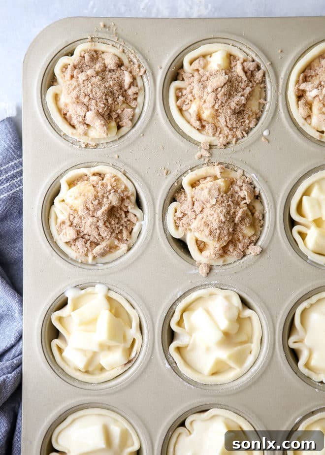 Freshly baked mini apple pies with streusel topping
