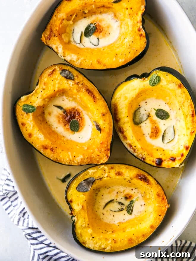 roasted acorn squash with sage cream sauce in baking dish