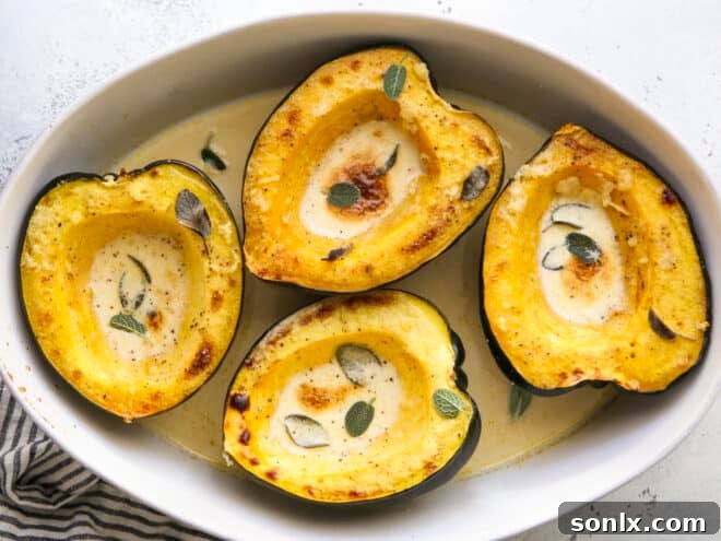 roasted acorn squash with sage cream sauce in baking dish