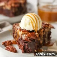 Pecan Pie Brownie with a bite taken out, covered in vanilla ice cream