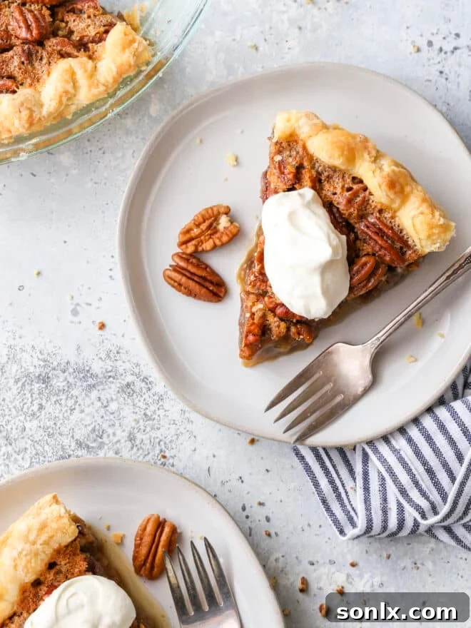 Pecan pie slices on plates, beautifully garnished with whipped cream, ready for a Thanksgiving dessert spread.