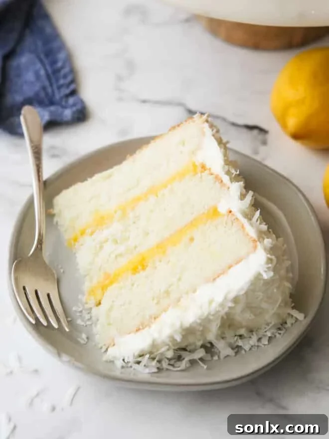 closeup of a slice of lemon coconut cake on a plate
