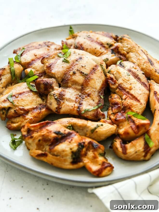 Perfectly grilled chicken pieces artfully arranged on a rustic plate, showcasing beautiful char marks
