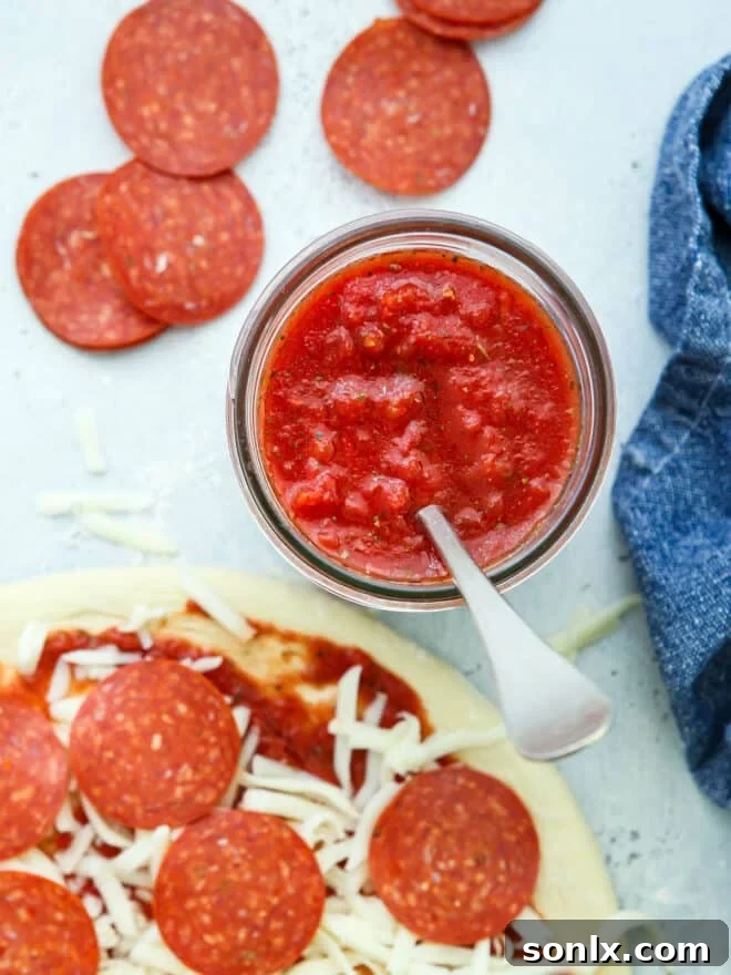 jar of pizza sauce and assembled pepperoni pizza