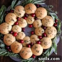 A festive holiday roll wreath on a serving plate.