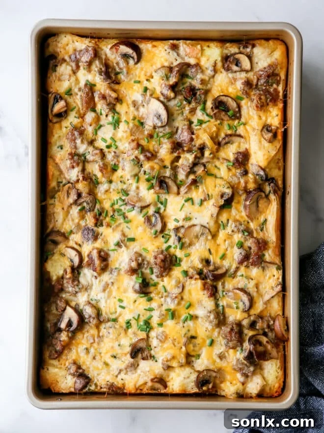 A hearty slice of baked sausage and mushroom breakfast casserole, ready for reheating.