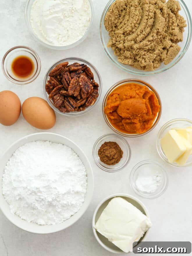 Ingredients for pumpkin roll laid out and measured, including flour, spices, pumpkin puree, and dairy.
