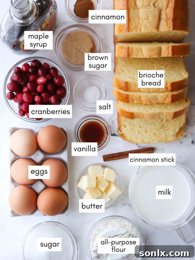 Ingredients for baked French toast, including bread, eggs, milk, sugar, vanilla, flour, brown sugar, cinnamon, butter, maple syrup, and cranberries.