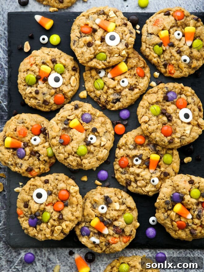 Vibrant Halloween Monster Cookies loaded with candy on a black serving tray, ready for spooky season