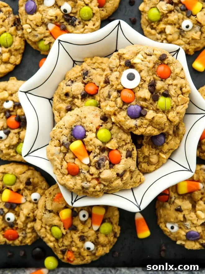 Halloween Monster Cookies displayed beautifully in a unique spiderweb-themed bowl, perfect for a spooky party