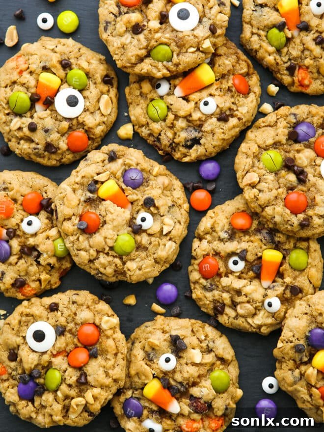 A tantalizing close-up of a freshly baked Halloween monster cookie, showcasing its vibrant mix-ins and edible eyes