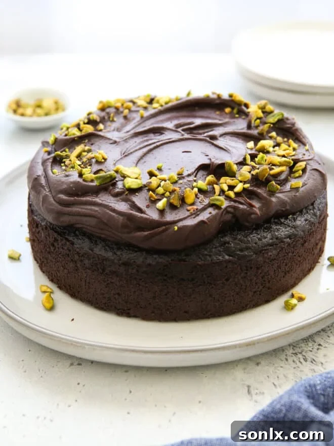 Decadent Chocolate Olive Oil Cake on a elegant serving plate, garnished with pistachios