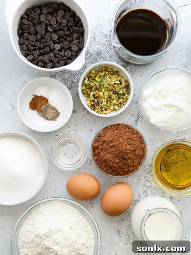 Carefully measured ingredients for chocolate olive oil cake laid out on a kitchen counter