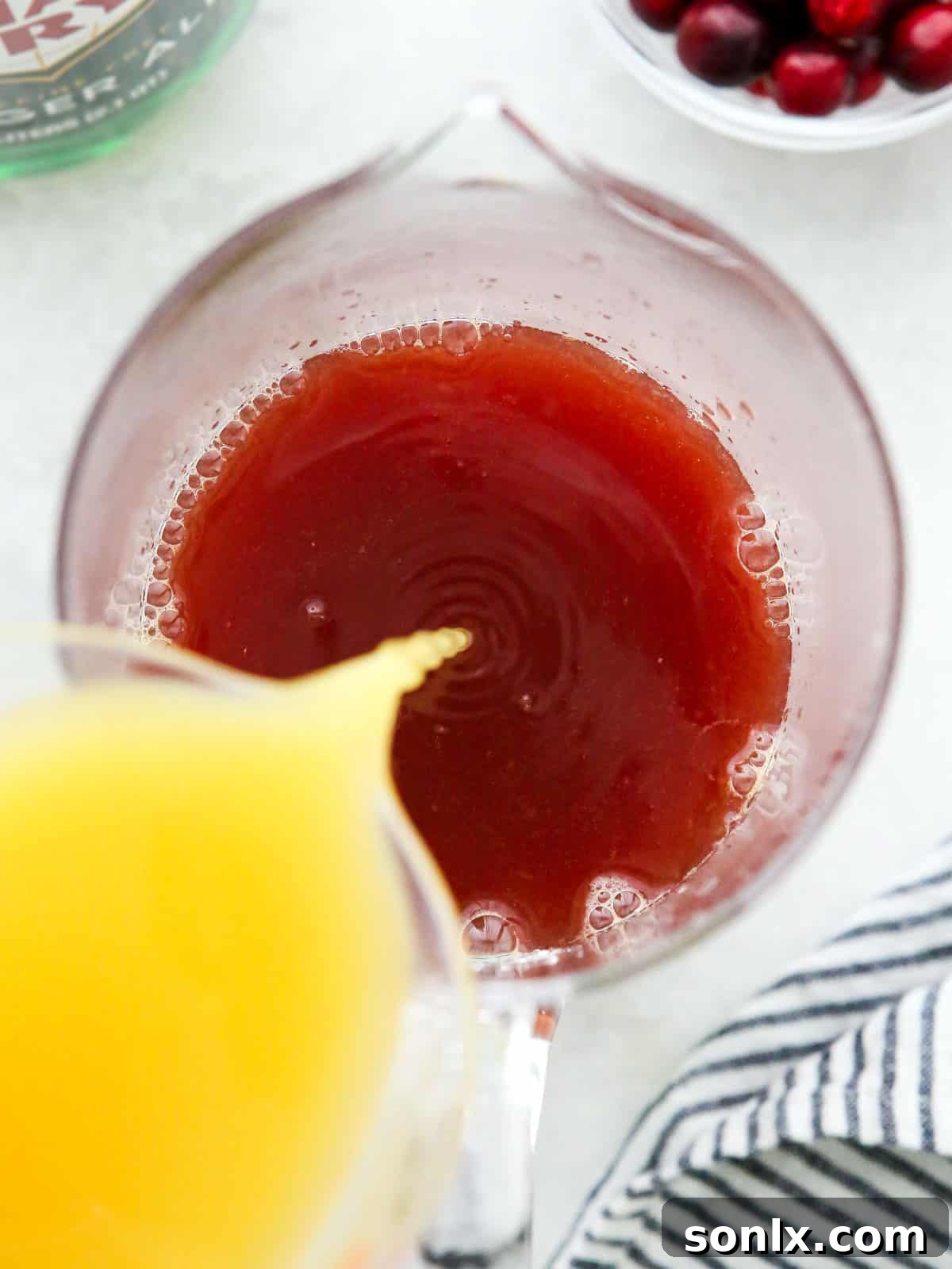 mixing holiday punch in a pitcher