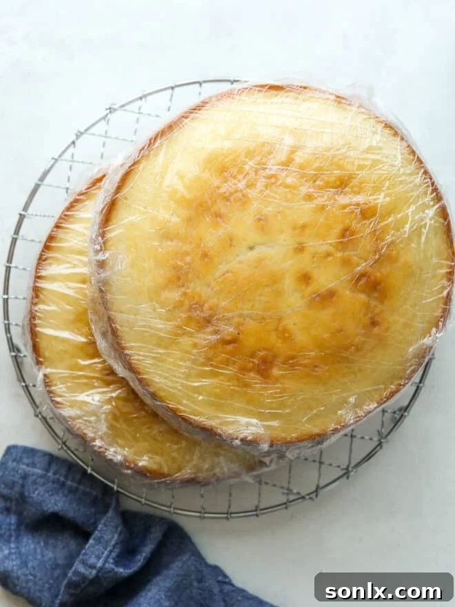 Freshly baked cake layer cooling on a wire rack.