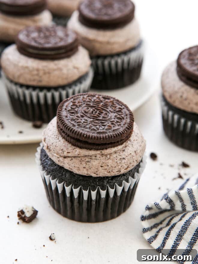 Beautiful Oreo cupcake with platter of cupcakes behind it