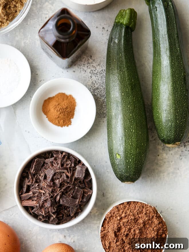 Neatly arranged bowls containing all the measured ingredients for chocolate zucchini bread, including flour, cocoa, sugars, and spices, ready for mixing.