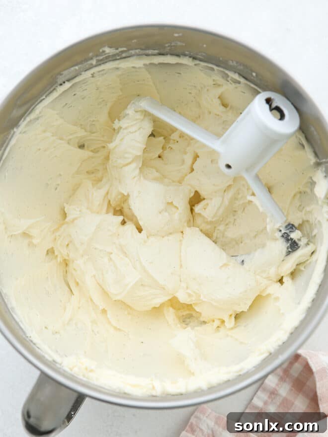 Mixing ingredients to make sweet vanilla buttercream frosting