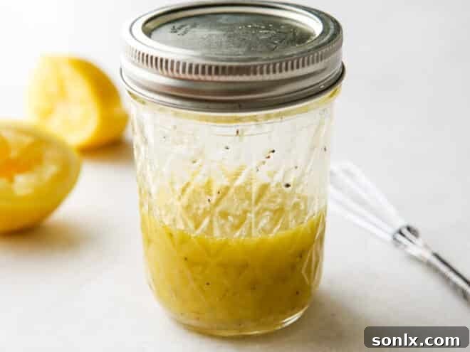 A jar containing freshly mixed lemon-parmesan vinaigrette, ready to be used.