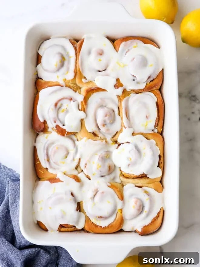 Glazed lemon cinnamon rolls artfully arranged in a baking pan, ready to be served