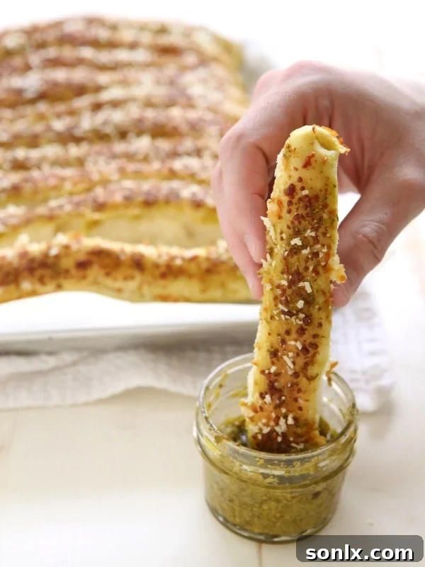 Finished Pesto Parmesan Pull Apart Breadsticks, golden brown and garnished