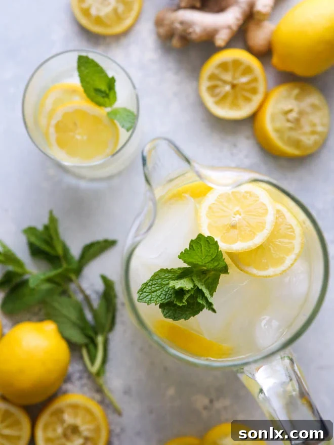 Citrus Zing with a Ginger Kick 4 Close-up of a refreshing glass of ginger lemonade with ice, lemon slices, and fresh mint, ready to be enjoyed on a warm day