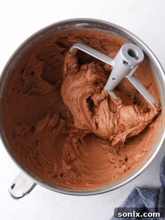 easy fudge frosting in a mixing bowl with a spatula