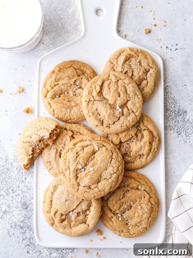 Golden brown brown butter chipless cookies stacked on a cooling rack, showcasing their rich, buttery texture and crisp edges.