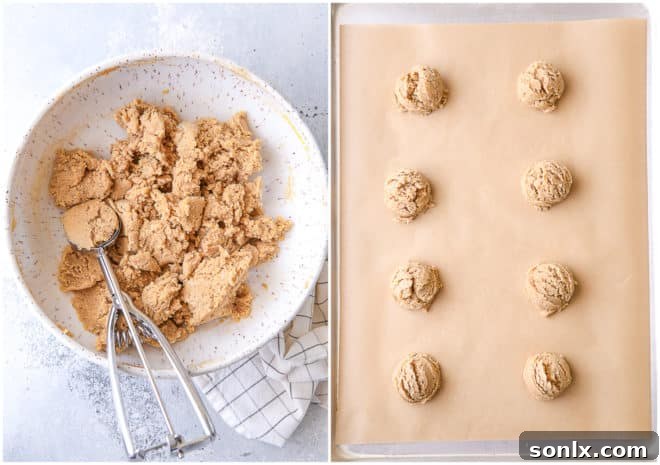 Portioned cookie dough balls ready for baking on a parchment-lined sheet pan.