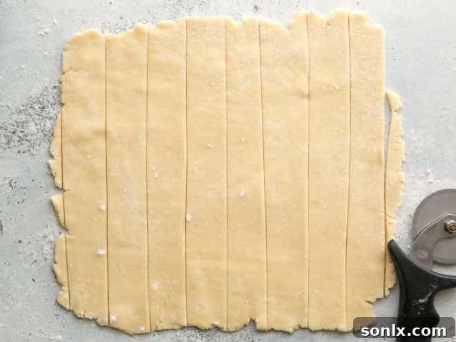 Pie crust dough rolled out and ready for cutting into strips for lattice