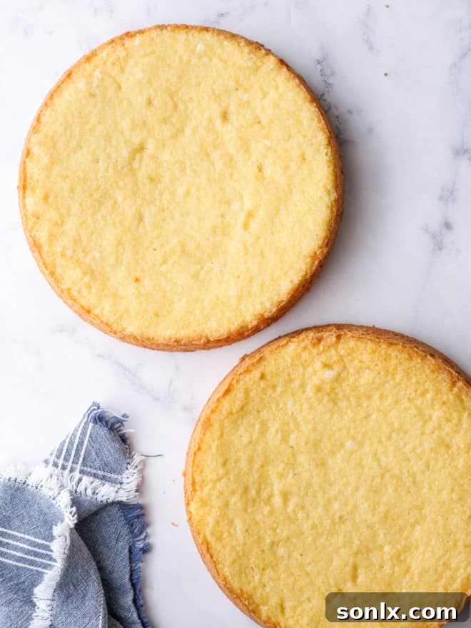 Close-up view of perfectly baked golden yellow cake layers, stacked and ready for assembly