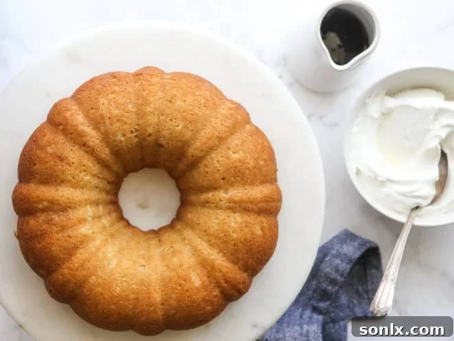 maple bundt cake with bowl of whipped cream and maple syrup