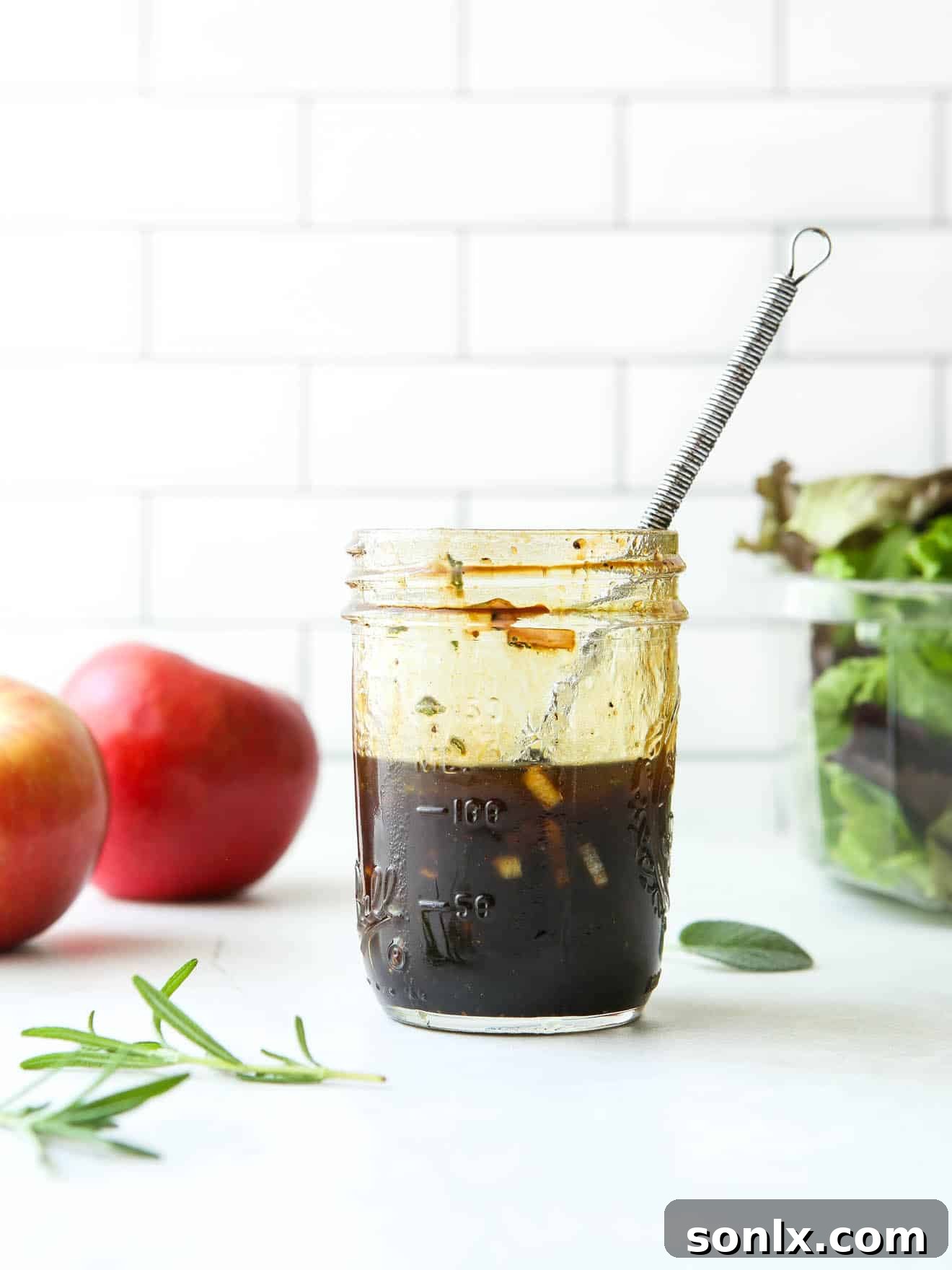 maple balsamic vinaigrette in a jar with whisk