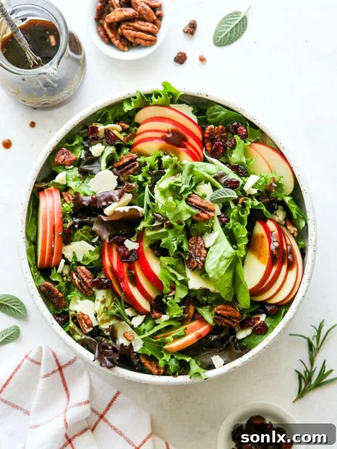 mixed fall apple salad with jar of dressing on side