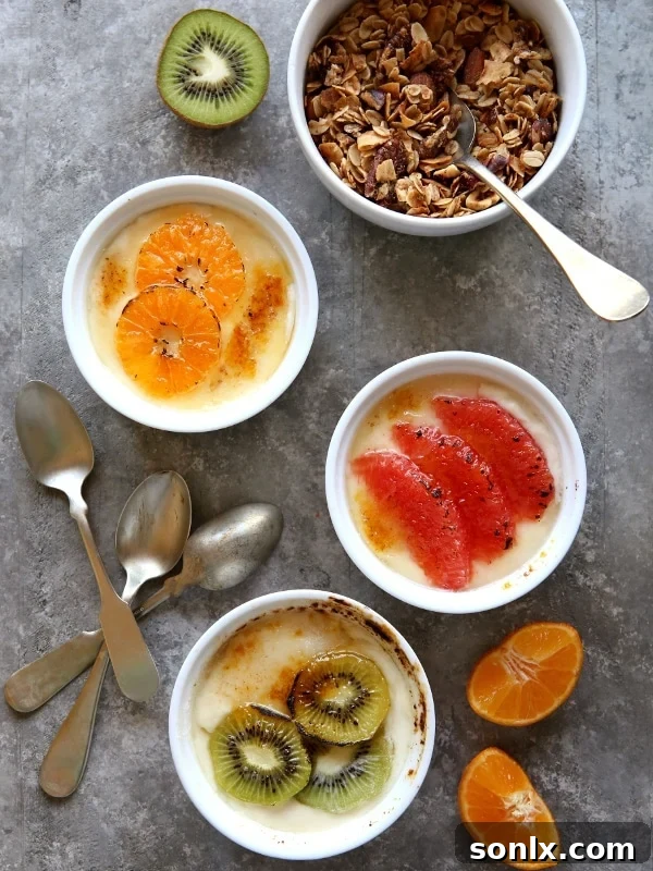 Delicious Yogurt Brûlée topped with caramelized sugar and fresh winter fruits including grapefruit, kiwi, and clementines. Perfect for a bright breakfast.