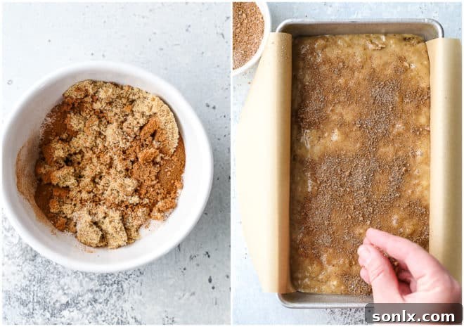 Sprinkling cinnamon crumble topping over banana bread batter in a loaf pan before baking, showcasing the final preparation step.
