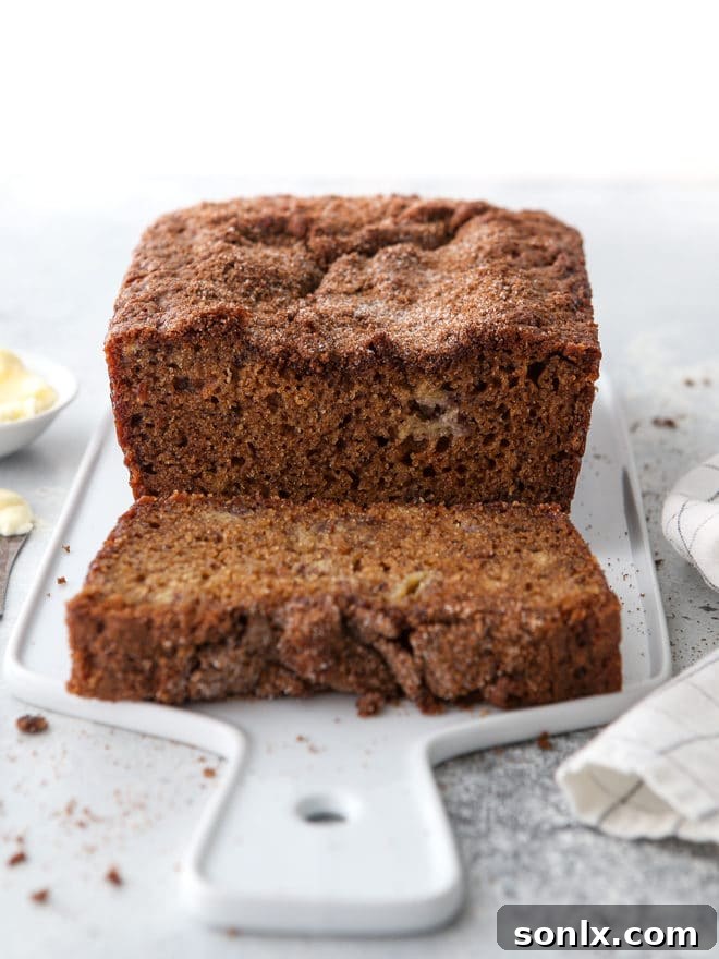 A beautiful top-down view of a whole cinnamon crumble banana bread loaf, showcasing its perfect golden crust and appealing streusel.