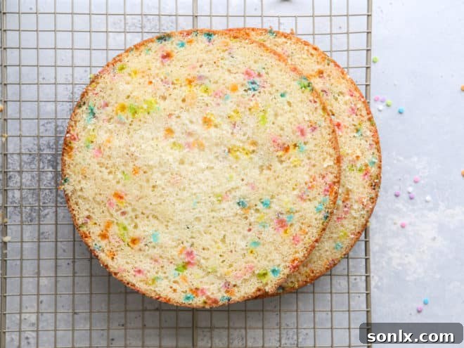 Freshly baked funfetti cake layers, perfectly golden and ready to be leveled for assembly.