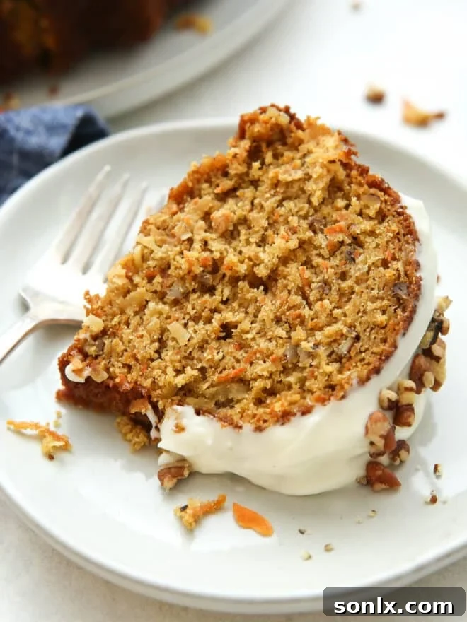 Close-up shot of a slice of carrot bundt cake showing its moist texture and mix-ins
