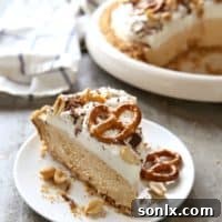 Peanut Butter Mousse Pie with Marshmallow Whipped Cream and Pretzel Crust | completelydelicious.com