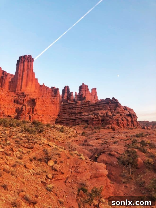 Dramatic and unique red rock spires of Fisher Towers standing tall against a bright blue sky, a climber's paradise